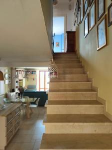 a staircase leading up to a living room and kitchen at Ciliano 16 in Montepulciano +8 photos
