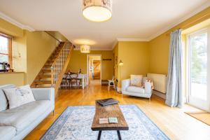 a living room with a couch and a table at Waun Yscir Rural escape in the Brecon Beacons in Brecon +23 photos