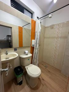 a bathroom with a toilet and a sink at HOTEL BLUE GUATAPE in Guatapé +24 photos