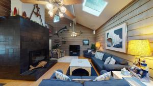a living room with blue couches and a fireplace at Ocean Retreat in Jekyll Island