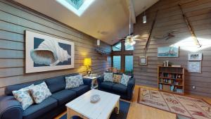 a living room with a blue couch and a table at Ocean Retreat in Jekyll Island