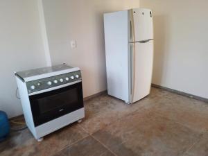 a kitchen with a stove and a refrigerator at Casa do Comendador in Uberaba