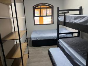 a room with two bunk beds and a window at Chácara piscina aquecida in Juazeiro do Norte +52 photos