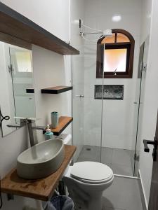 a bathroom with a sink and a toilet and a shower at Chácara piscina aquecida in Juazeiro do Norte