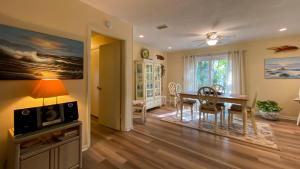 a living room with a table and a dining room at Island Pines in Jekyll Island