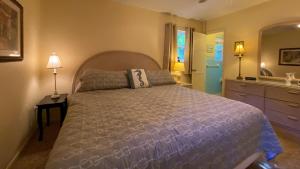 a bedroom with a large bed and a sink at Island Pines in Jekyll Island