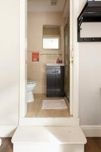 a bathroom with a toilet and a sink at Molloys Apartments in Dublin
