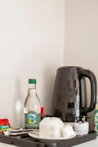 a bottle of water sitting on a counter next to a kettle at Molloys Apartments in Dublin