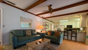 a living room with a couch and a table at Hollybourne II in Jekyll Island