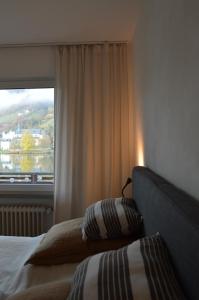 a bedroom with a bed and a large window at Ferienwohnung Grüne Boje in Bullay