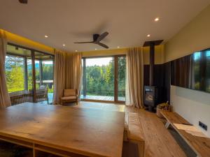 a living room with a wooden table and a large window at Eho Resort in Ilʼtsya Gurny