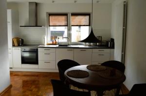 a kitchen with a table and a sink and a stove at Ferienwohnung Grüne Boje in Bullay