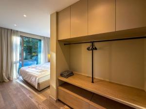 a bedroom with a bed and a large window at Eho Resort in Ilʼtsya Gurny +56 photos