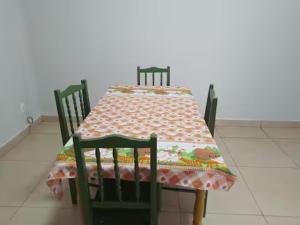 a table with two chairs and a table cloth on it at Casa de Carolinda in Uberaba
