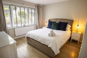 a bedroom with a bed with two teddy bears on it at Skiddaw Heights in Keswick