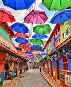 a bunch of umbrellas hanging over a street at HOTEL BLUE GUATAPE in Guatapé +23 photos