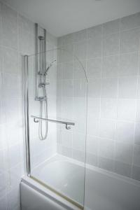 a shower with a glass door in a bathroom at Skiddaw Heights in Keswick