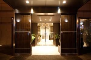 an entrance to a building with doors and plants at Dormy Inn Nagano in Nagano +37 photos