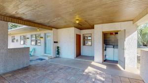 a porch of a home with a wooden ceiling at Americana Beach in Jekyll Island