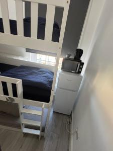 a bunk bed in a room with a bed in a room at Trio Den in Zone 2 - Willesden Green in London