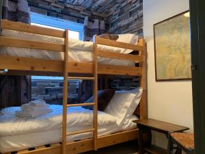 a couple of bunk beds in a room at The Maisonette - Central Windermere, with parking in Windermere