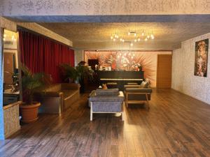 a living room with a grand piano and furniture at Jazz Hotel in Tbilisi City +68 photos