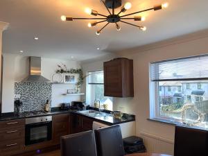 a kitchen with a ceiling fan and a kitchen table at The Maisonette - Central Windermere, with parking in Windermere