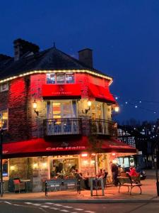 a building with a restaurant on a street at night at The Maisonette - Central Windermere, with parking in Windermere
