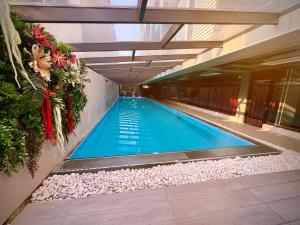 a large swimming pool in a building at Jazz Hotel in Tbilisi City