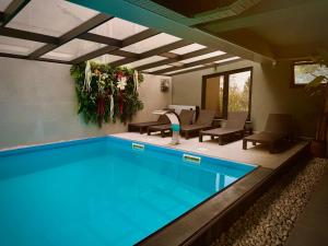 a swimming pool with chairs and a table at Jazz Hotel in Tbilisi City
