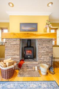 a fireplace in a living room with a stove at Waun Yscir Rural escape in the Brecon Beacons in Brecon