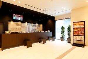 a restaurant lobby with a counter and a kitchen at Dormy Inn Nagano in Nagano