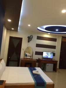 a bedroom with a bed and a tv on a ceiling at Sunny B Hotel in Hue