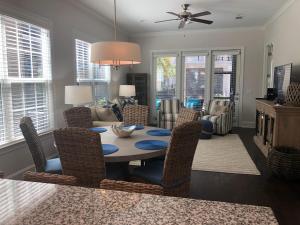 a dining room and living room with a table and chairs at Honu Kai in Jekyll Island