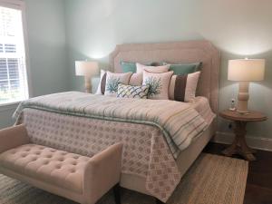 a bedroom with a large bed with pillows at Honu Kai in Jekyll Island +41 photos