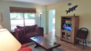 a living room with a couch and a table at Ariel West Duplex in Jekyll Island