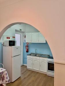 a kitchen with an archway in the middle of it at Nazaré Stay Home - Alecrim T2 in Nazaré +1 photo