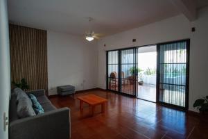 a living room with a couch and a table at Casa Rubí comfortable and with a private pool in Zihuatanejo