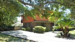 a brick house with an orange roof at Ariel East Duplex in Jekyll Island