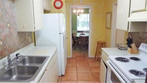 a kitchen with a sink and a stove at Ariel East Duplex in Jekyll Island