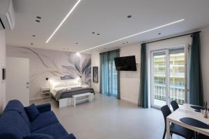 a living room with a bed and a couch at Meraviglia B&B - Salerno Centro Close to the Station and Pier in Salerno