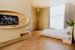 um quarto com uma cama e uma janela grande em cithara villa em Kejajar