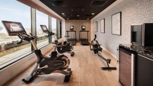 a row of exercise bikes in a gym with windows at Hotel Indigo Torquay, By IHG in Torquay