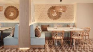 a dining room with a table and chairs at Hotel Indigo Torquay, By IHG in Torquay