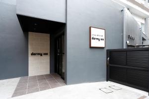 a entrance to a building with a sign on the wall at Dormy Inn Nagano in Nagano