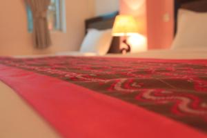 A bed or beds in a room at Grand Laurel Hotel