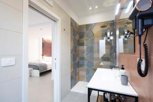 a bathroom with a shower and a sink in a room at Meraviglia B&B - Salerno Centro Close to the Station and Pier in Salerno +269 photos