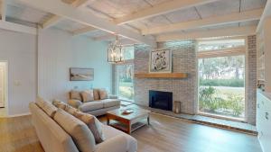 a living room with a couch and a fireplace at Meet Me At Sunset in Jekyll Island