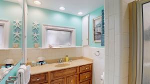 a bathroom with a sink and a shower at Meet Me At Sunset in Jekyll Island +31 photos