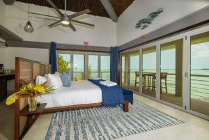 a bedroom with a bed with a view of the ocean at Luxury All-Inclusive Prince Private Island in San Pedro Island +34 photos